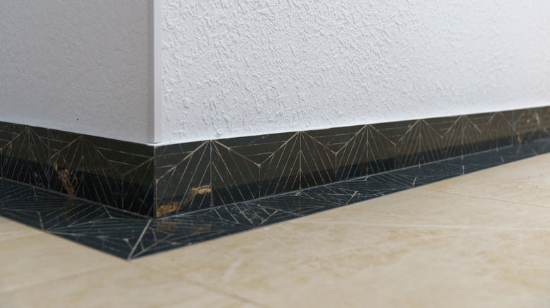 granite baseboard on a white wall