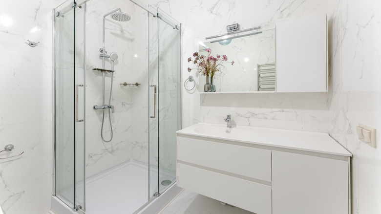 A tiled bathroom with shower and sink
