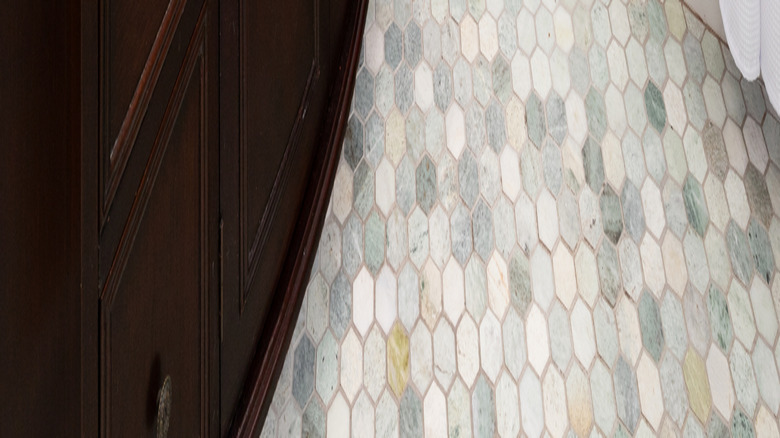 old fashioned hexagon tile floor and dark wood sink unit
