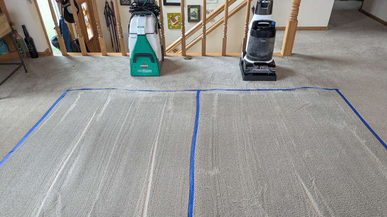 The Tineco and Bissell cleaners stand next to the sections of carpet they cleaned successfully.