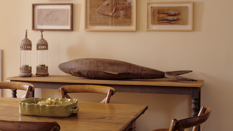 Fish-themed decor pieces and artwork in a dining room