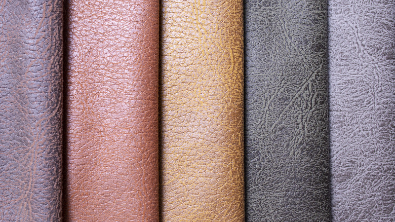 Colorfull rolls of leather in light browns and black