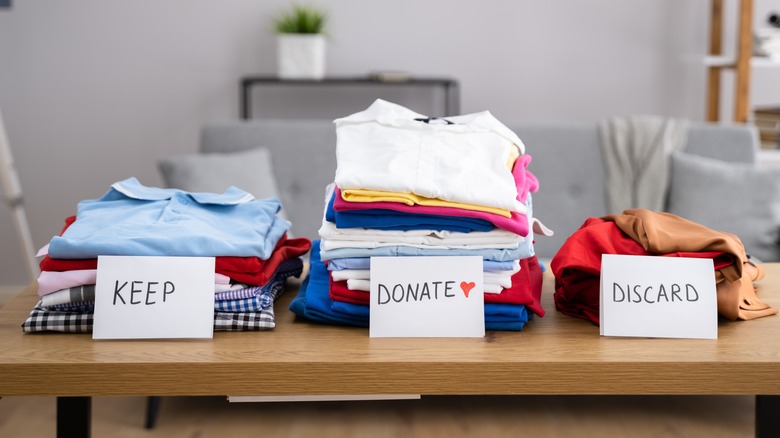 Clothes arranged in three piles on a table