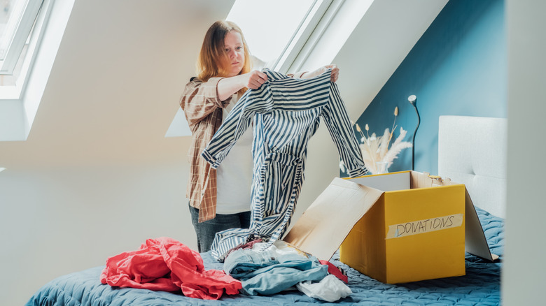 Clothes arranged in three piles on a table