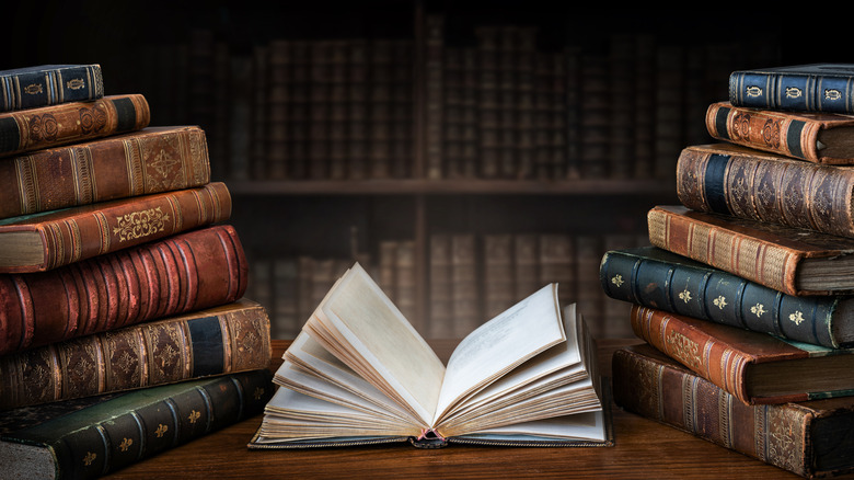 Stacked books with open book