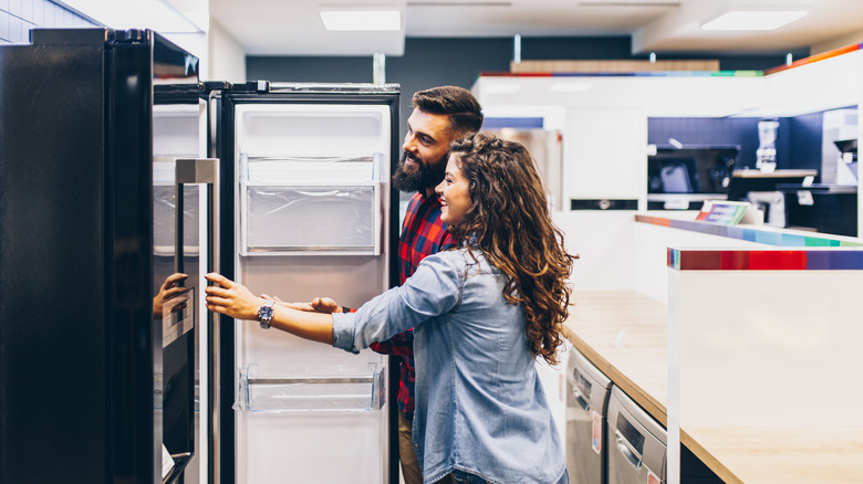 couple shopping for fridge