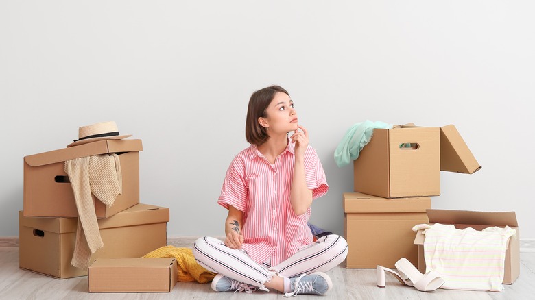 Person surrounded by storage boxes