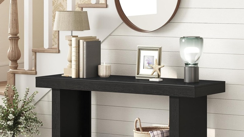 Candles placed on a mantel near entryway