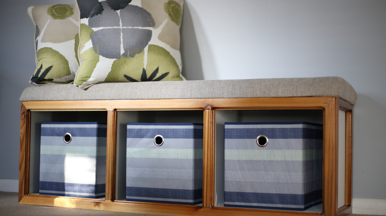 Bench with cushions on top and storage baskets underneath