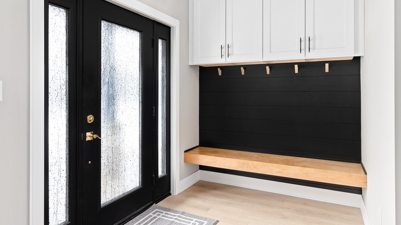 Bench seating in a white and black entryway
