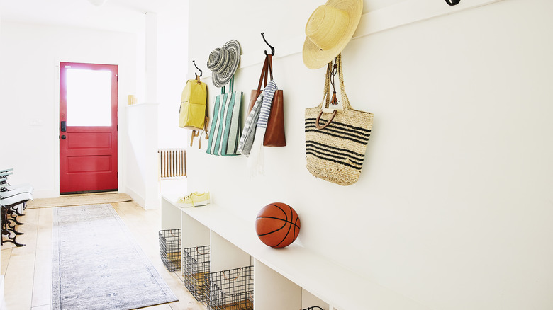 Bags and hats on hooks near entryway