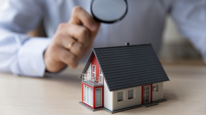 homeowner inspecting house model