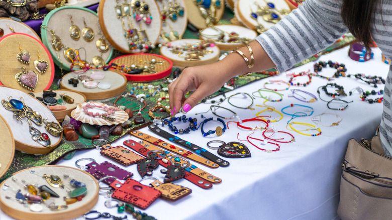 Woman shopping for jewelry at flea market