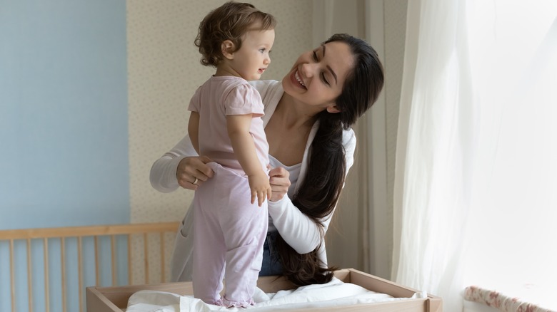 mom with baby on changing table 