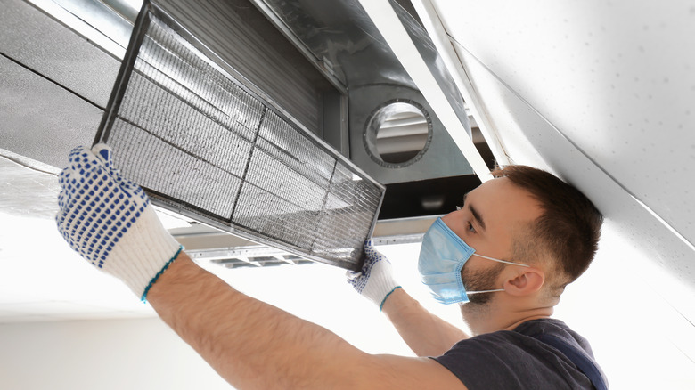 Man cleaning air conditioner