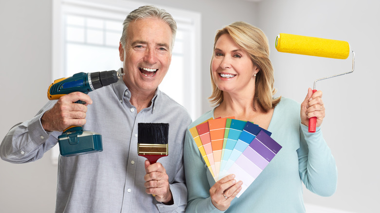 older couple with renovating tools
