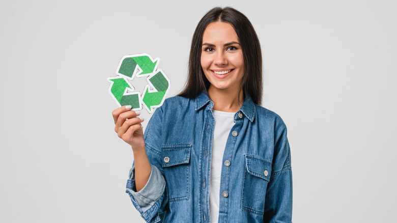 woman holding recycling symbol