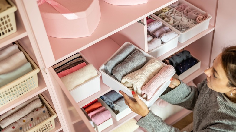 organized closet with plastic tubs