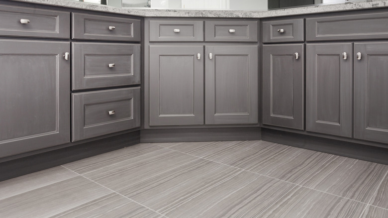 gray cabinets and porcelain tile floor