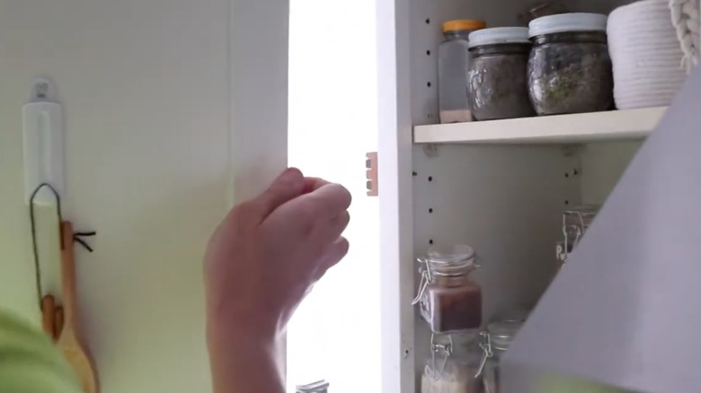 man removing kitchen cabinet door