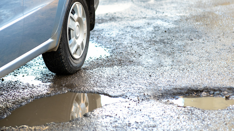 Car next to pothole