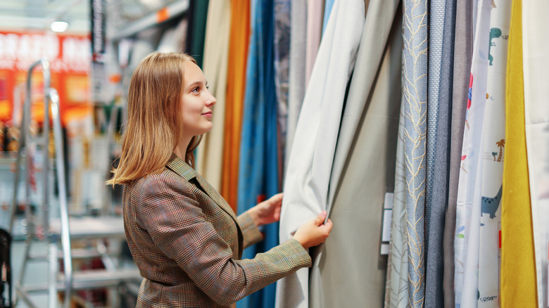 A person shops for curtains in store