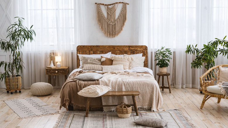 A boho bedroom with sheer white curtains