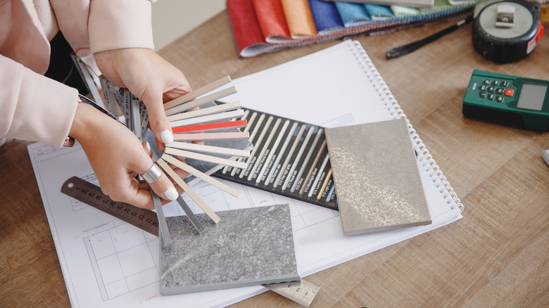 Person comparing tile samples