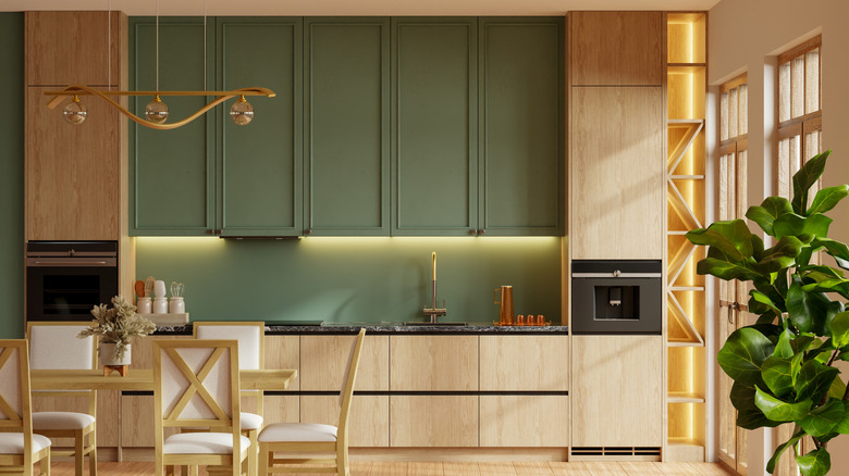 A kitchen with two-toned cabinets in natural wood and olive green