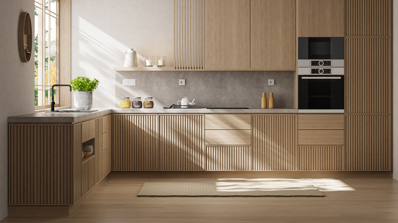 A clean, clutter-free kitchen with natural wood cabinetry