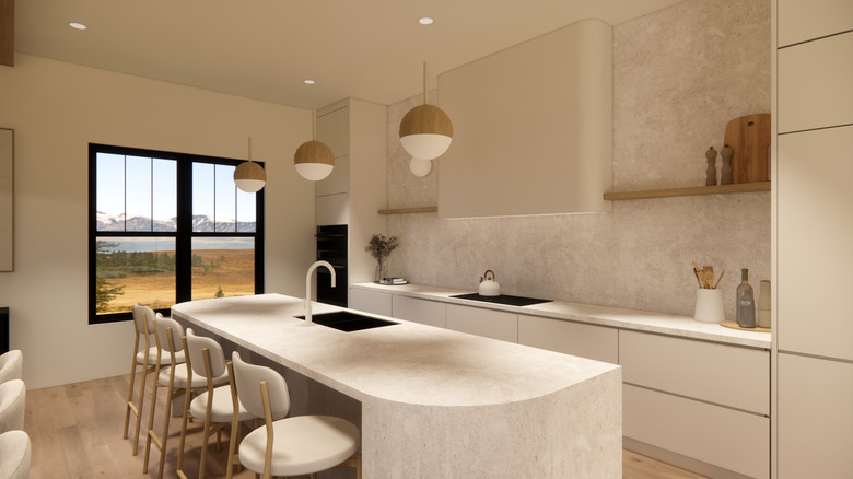 A luxury modern kitchen, including marble island with rounded corners on one side