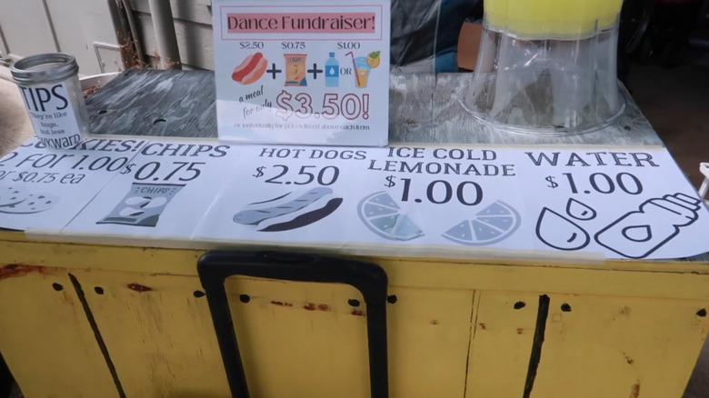 Stand with drinks and snacks set up at a garage sale