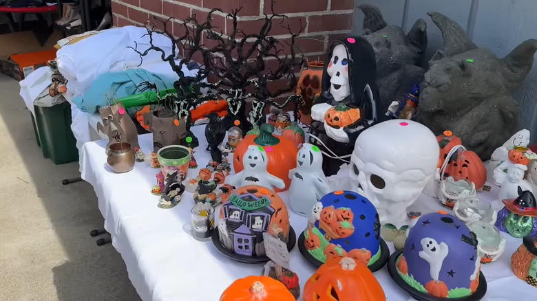 Garage sale table with Halloween decorations set up neatly