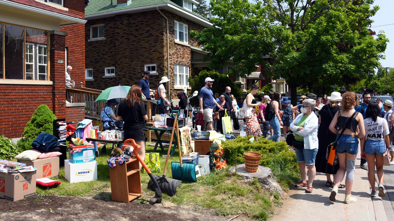 Yard sale with lots of people looking at items