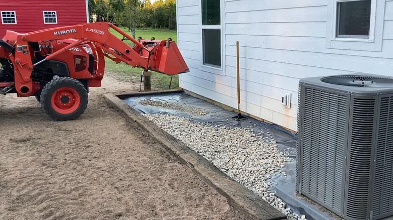 Railway sleepers being installed as lawn edging