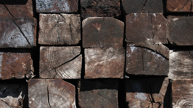 Stacked railroad ties that have been soaked in creosote
