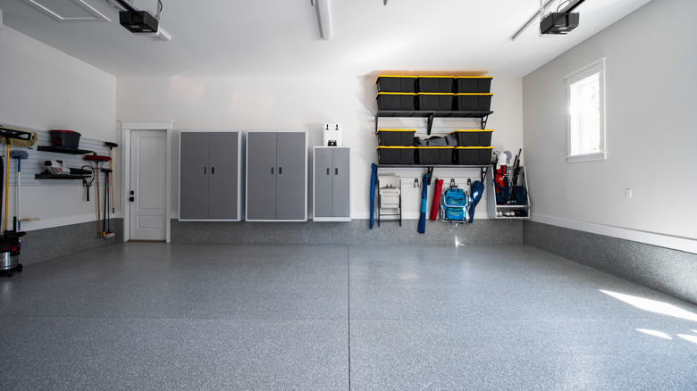 An interior view of a garage with a concrete floor