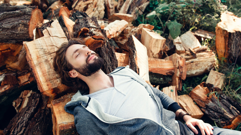 Tired man on firewood