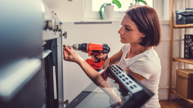 A person using a cordless drill