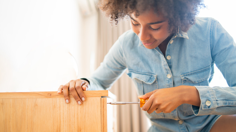 Woman using a screwdriver