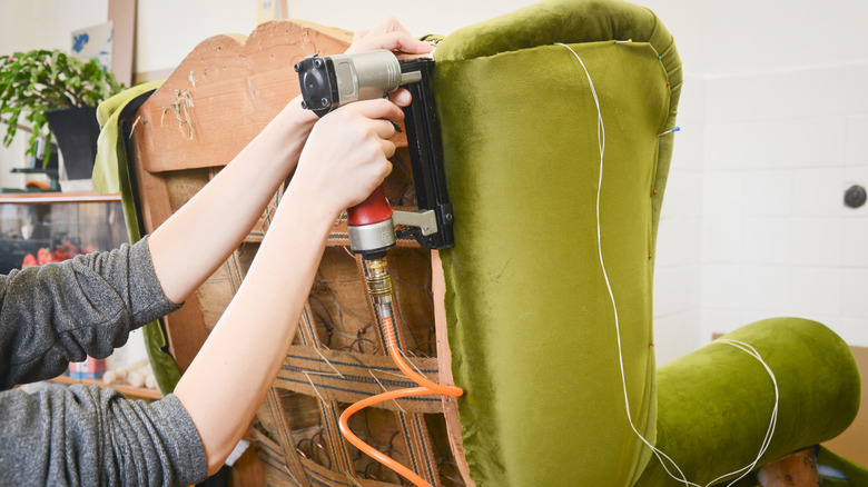 A person stapling furniture