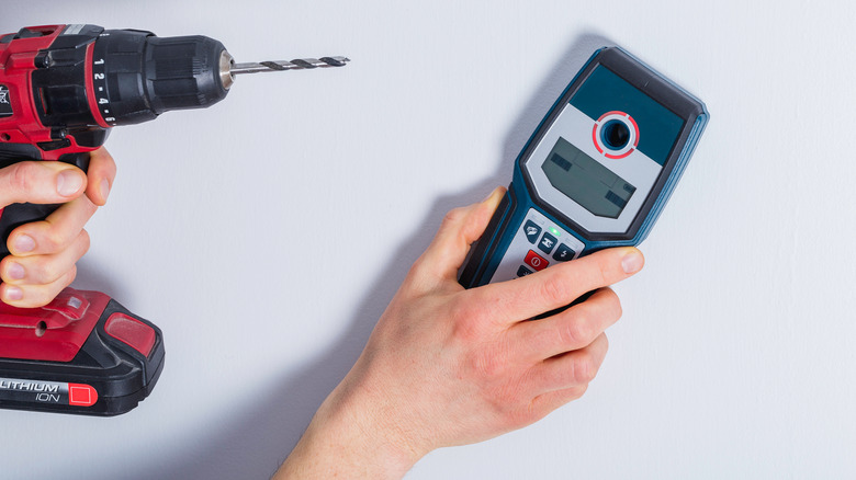 A person using a stud finder