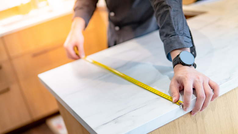 A man using measuring tape
