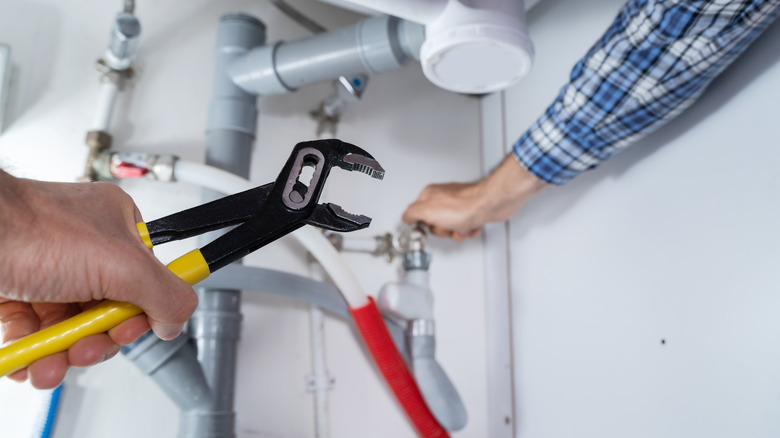 A person using a wrench