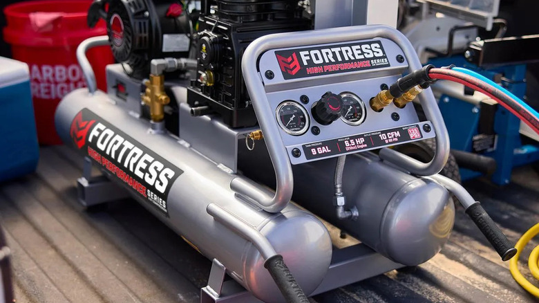 A Fortress air compressor in the bed of a pickup truck