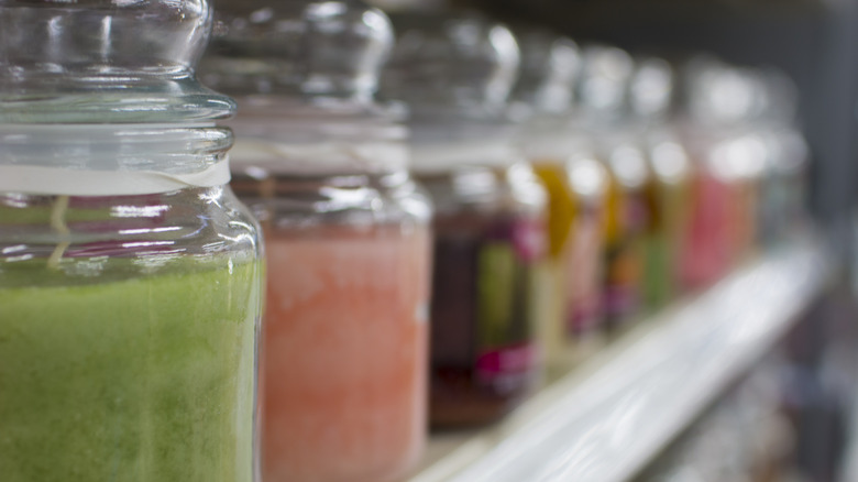 Close-up of generic candles in row on store shelf