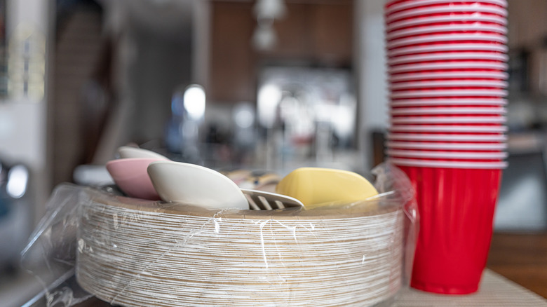 Close-up of paper and plastic party cups, napkins, plates, and cutlery