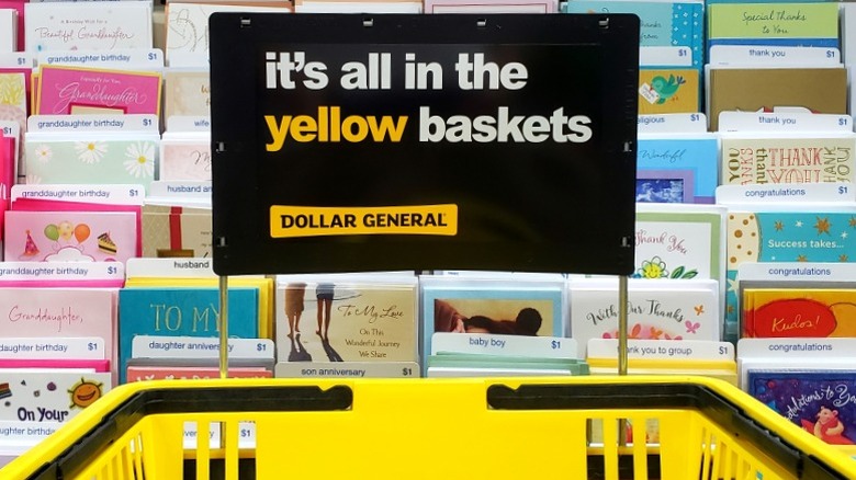 Dollar General shopping baskets in holder by greeting card display