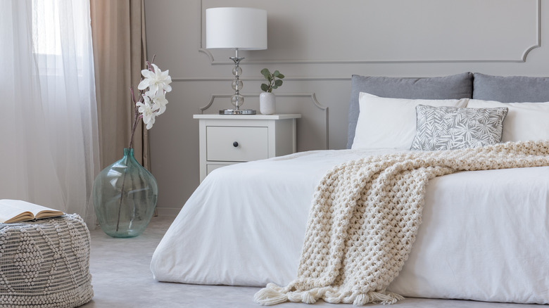 neutral bedroom with knit blanket