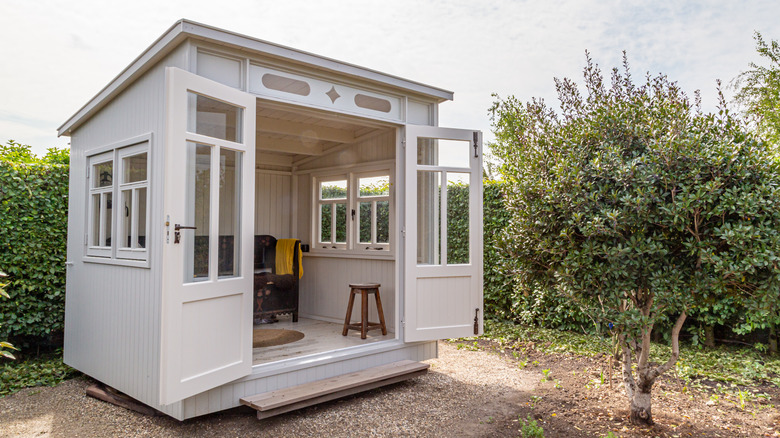 white shed outside open doors 